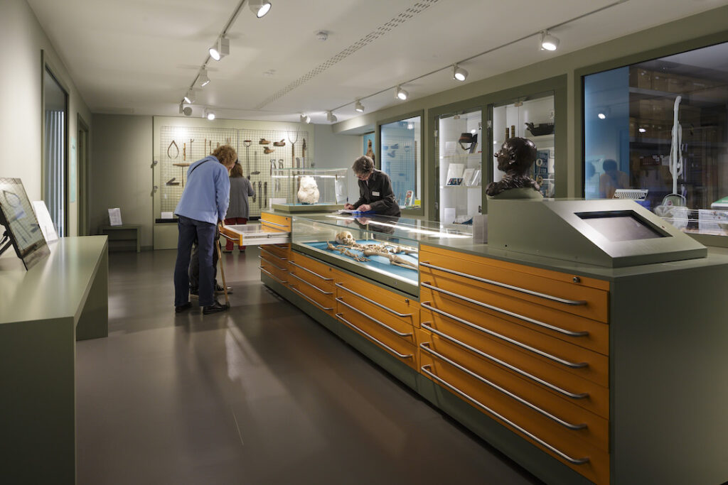 Two men discussing inside Epping Forest District Museum store.
