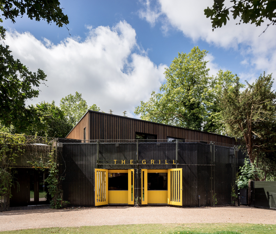 External view of the Open Air Theatre rehearsal studio surrounded by trees.